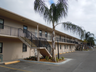 apartment complex with palm trees